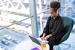 woman in black dress shirt using MacBook