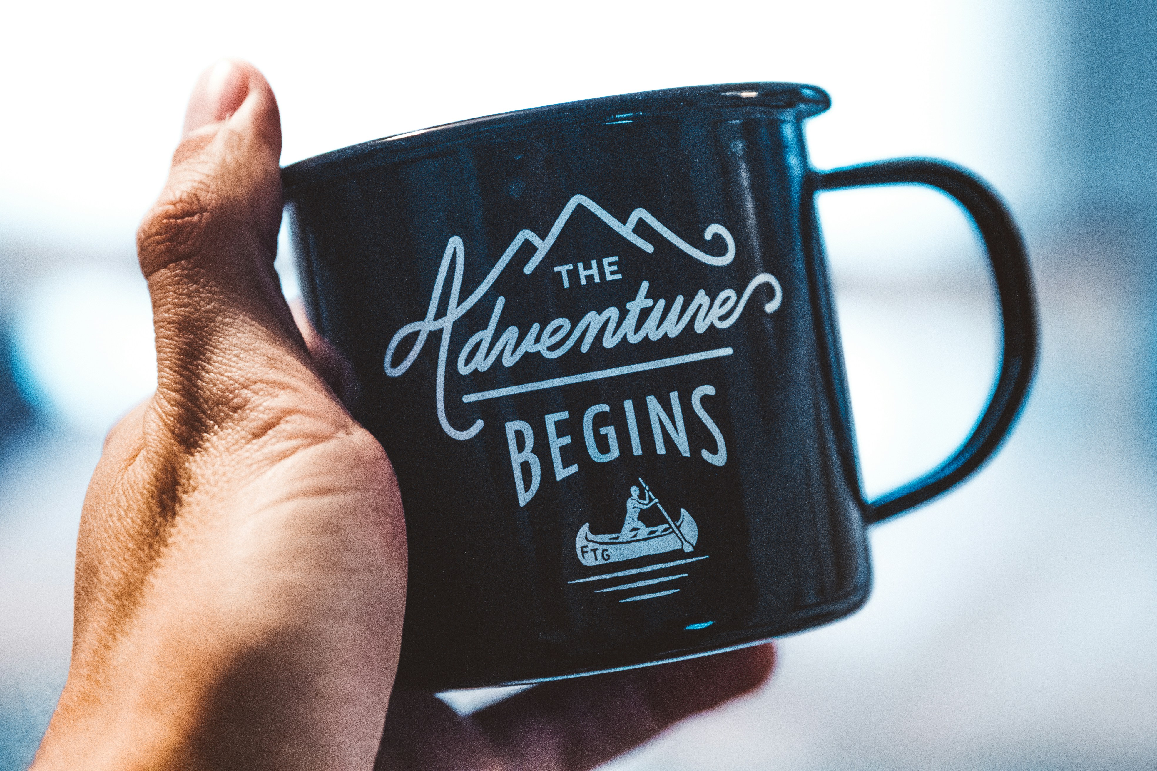person holding black mug