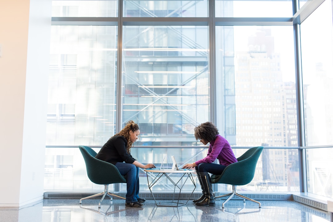 Two professionals discuss innovative technology solutions for optimizing business resource utilization.