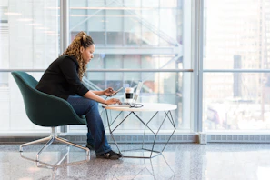 Portrait of a focused entrepreneur working in a modern office space with city views.