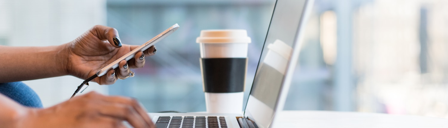 person using live-chat on smartphone and MacBook