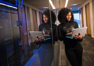 woman in black shirt using laptop computer