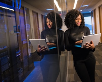 woman in black shirt using laptop computer