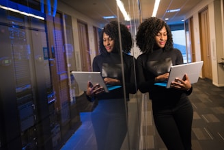 woman in black shirt using laptop computer