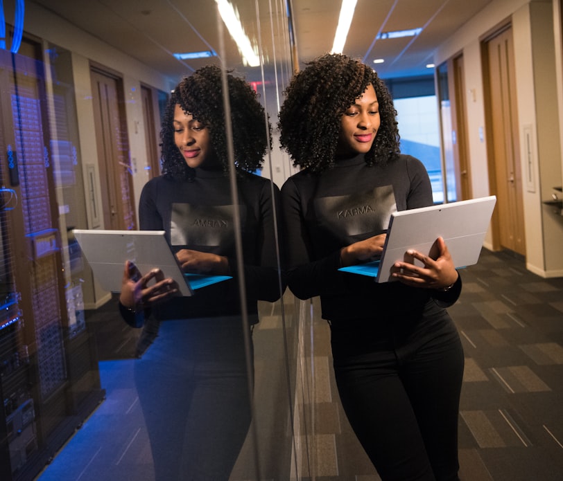 woman in black shirt using laptop computer