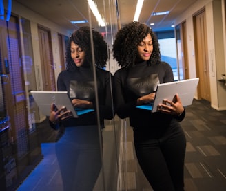 woman in black shirt using laptop computer