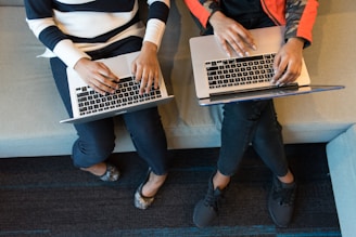 two women using MacBook Pro