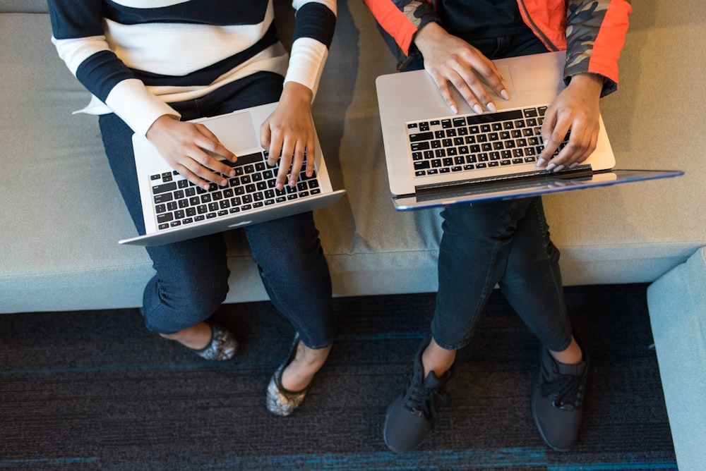 two women using MacBook Pro