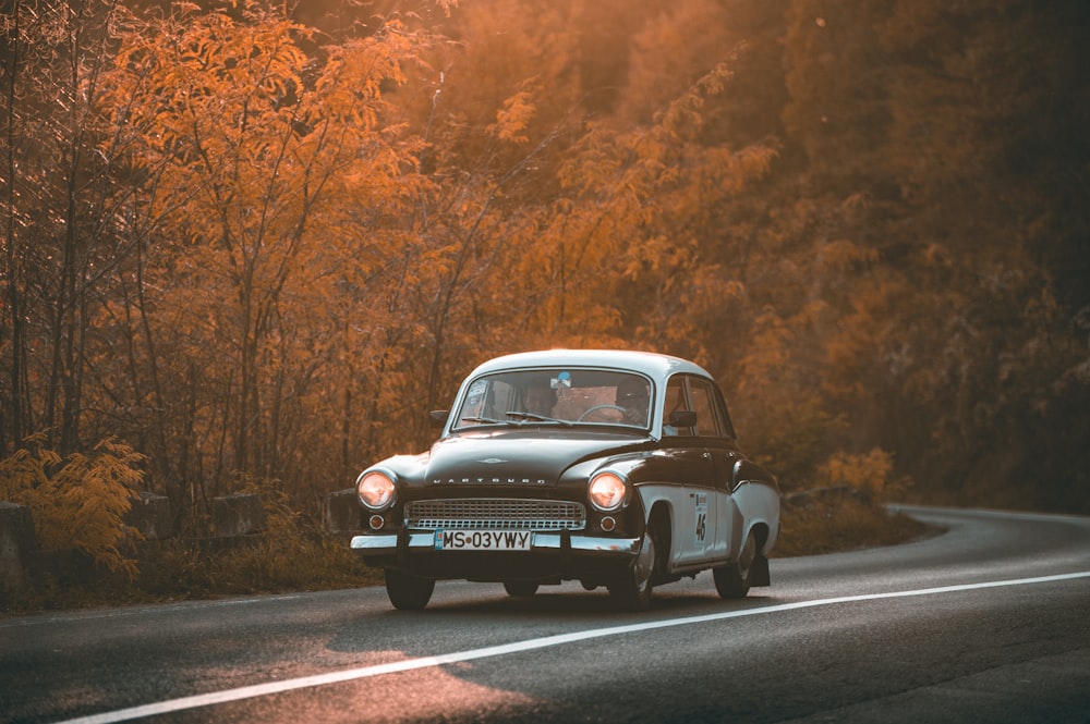 vintage gray and brown sedan on road during daytime