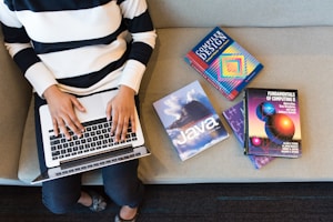 person in white and black striped top using MacBook
