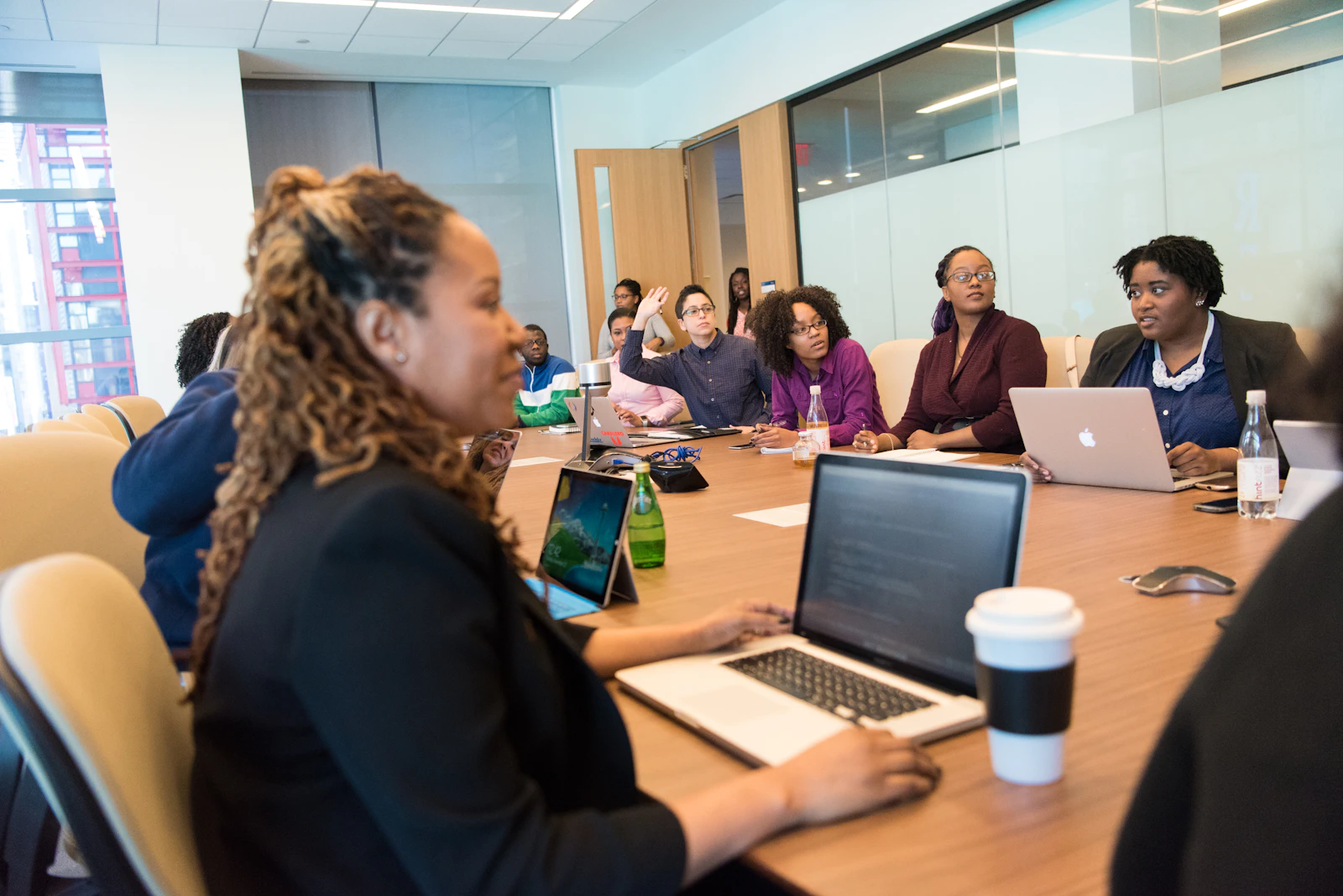 Diverse community group of Black and White adults seated together in a circle during an open discussion