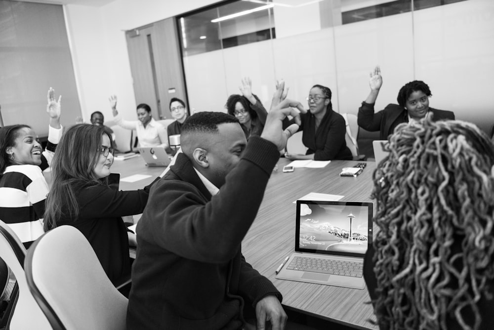 greyscale photo of people inside room