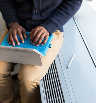 man sitting and using laptop