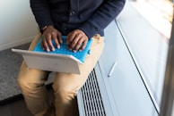 man sitting and using laptop