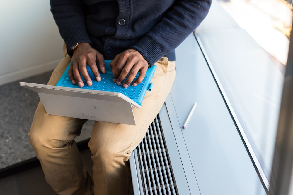 man sitting and using laptop