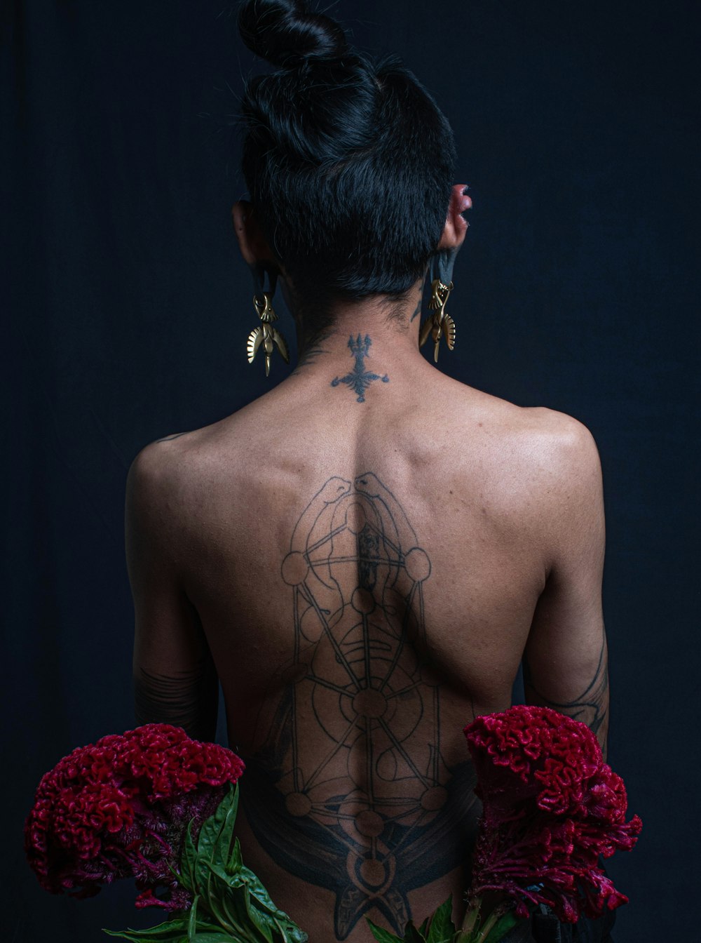 topless person with back tattoo