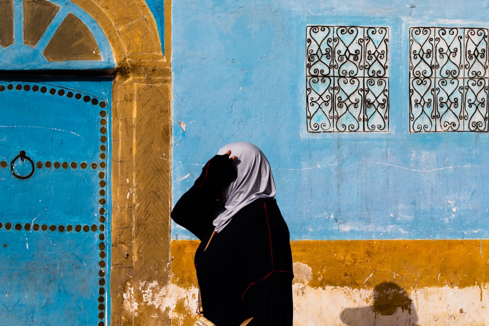 woman walking beside wall