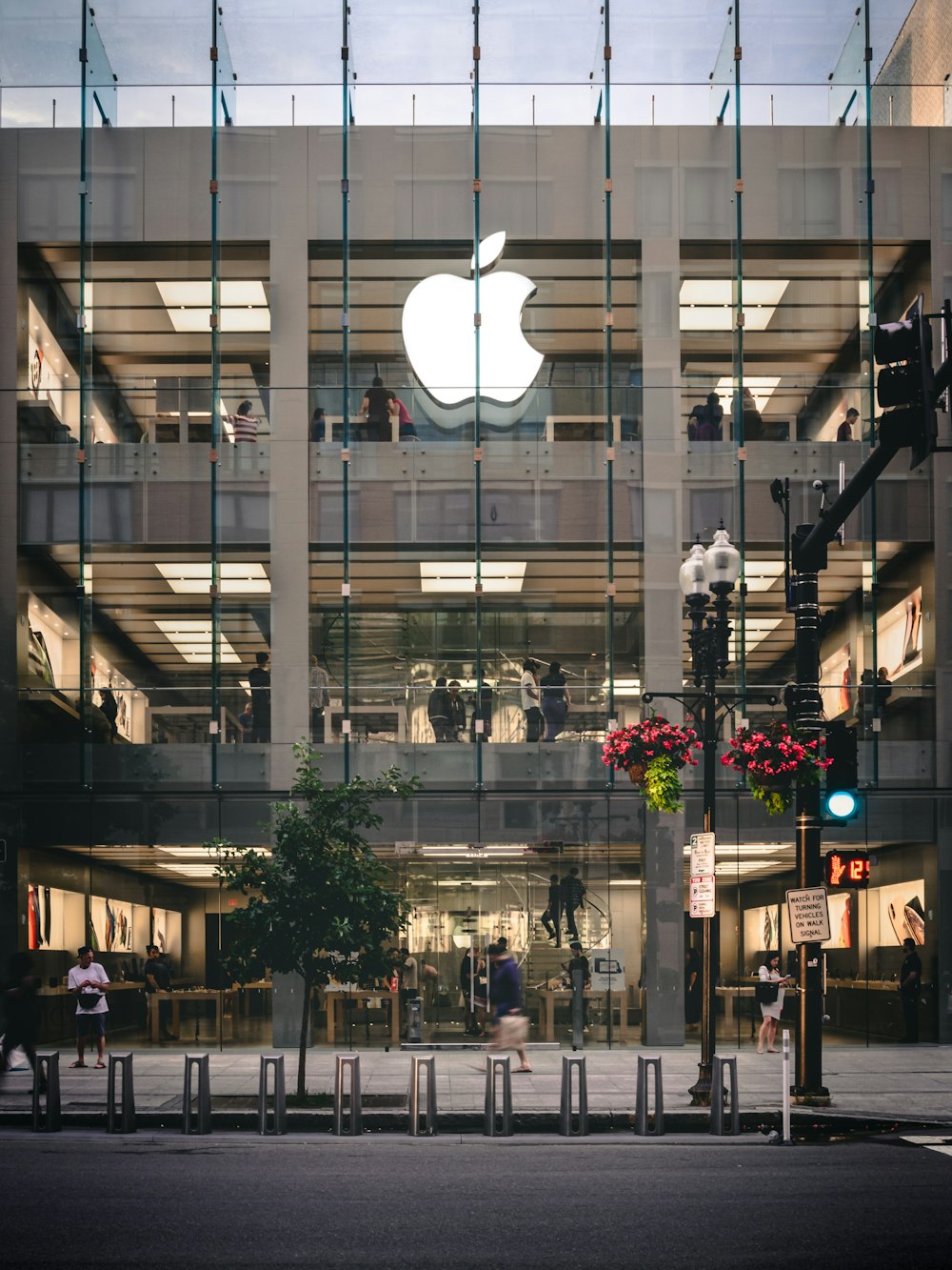 people walking beside Apple building during daytime