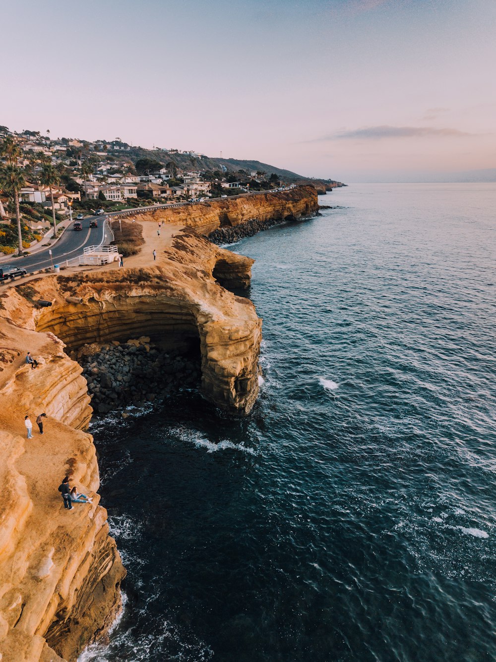 road on sea cliff during daytime