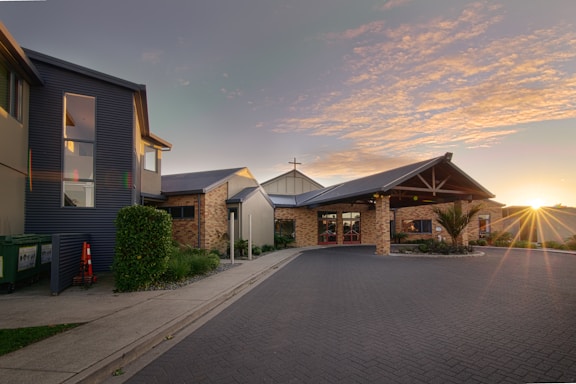 A warm, inviting church building with people gathered outside in fellowship.