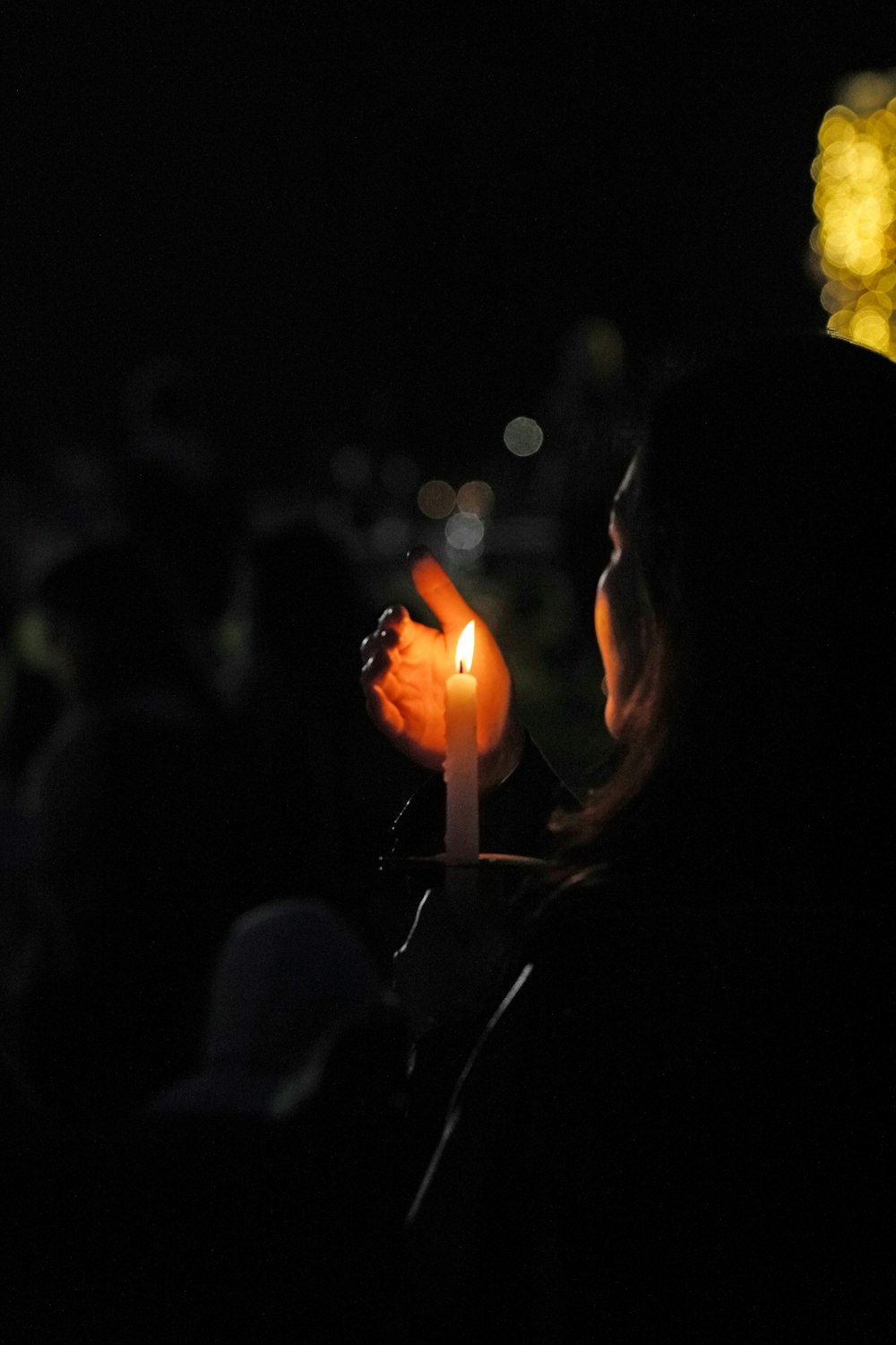 woman holding lit candle