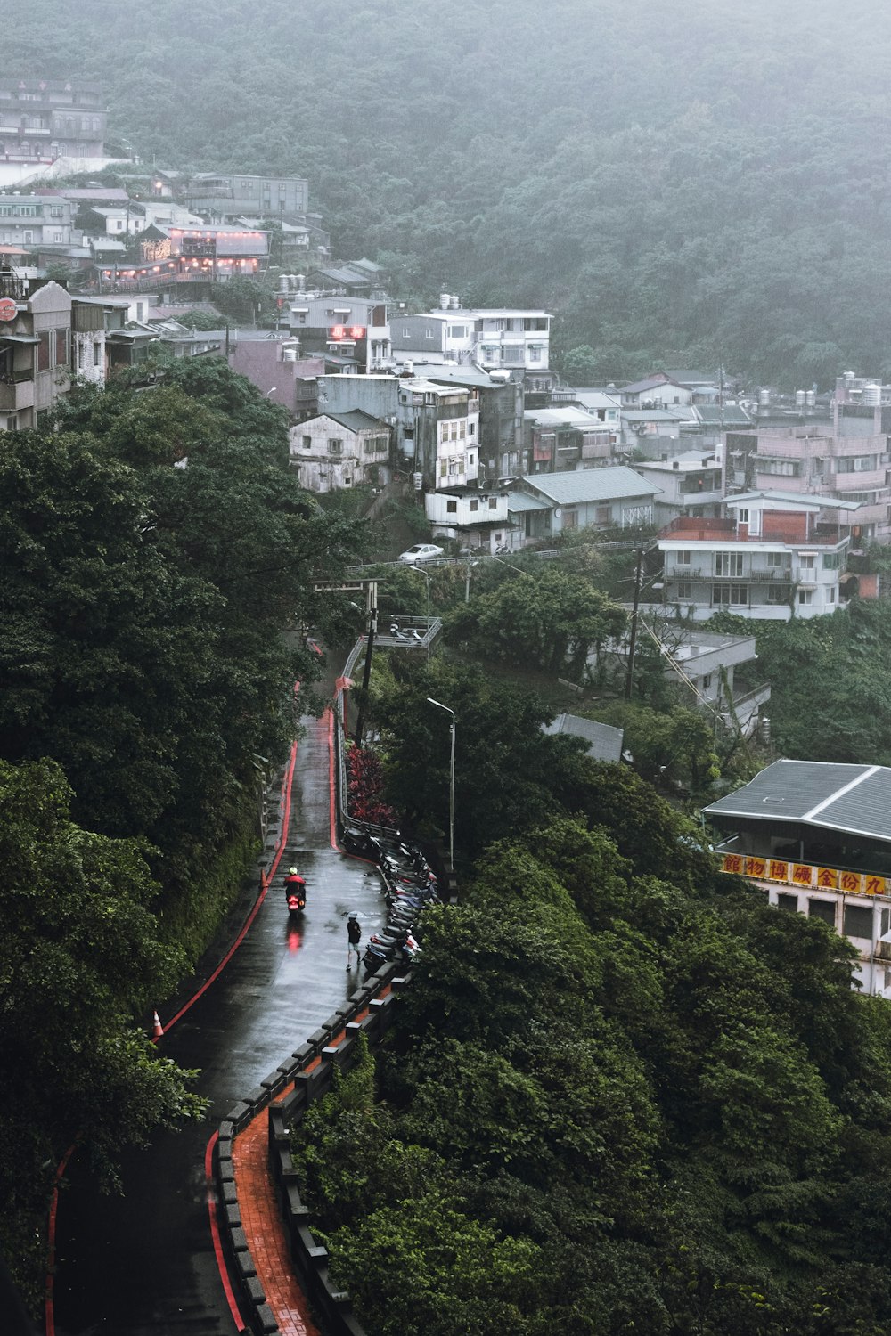 high-angle photography of asphalt road and houses