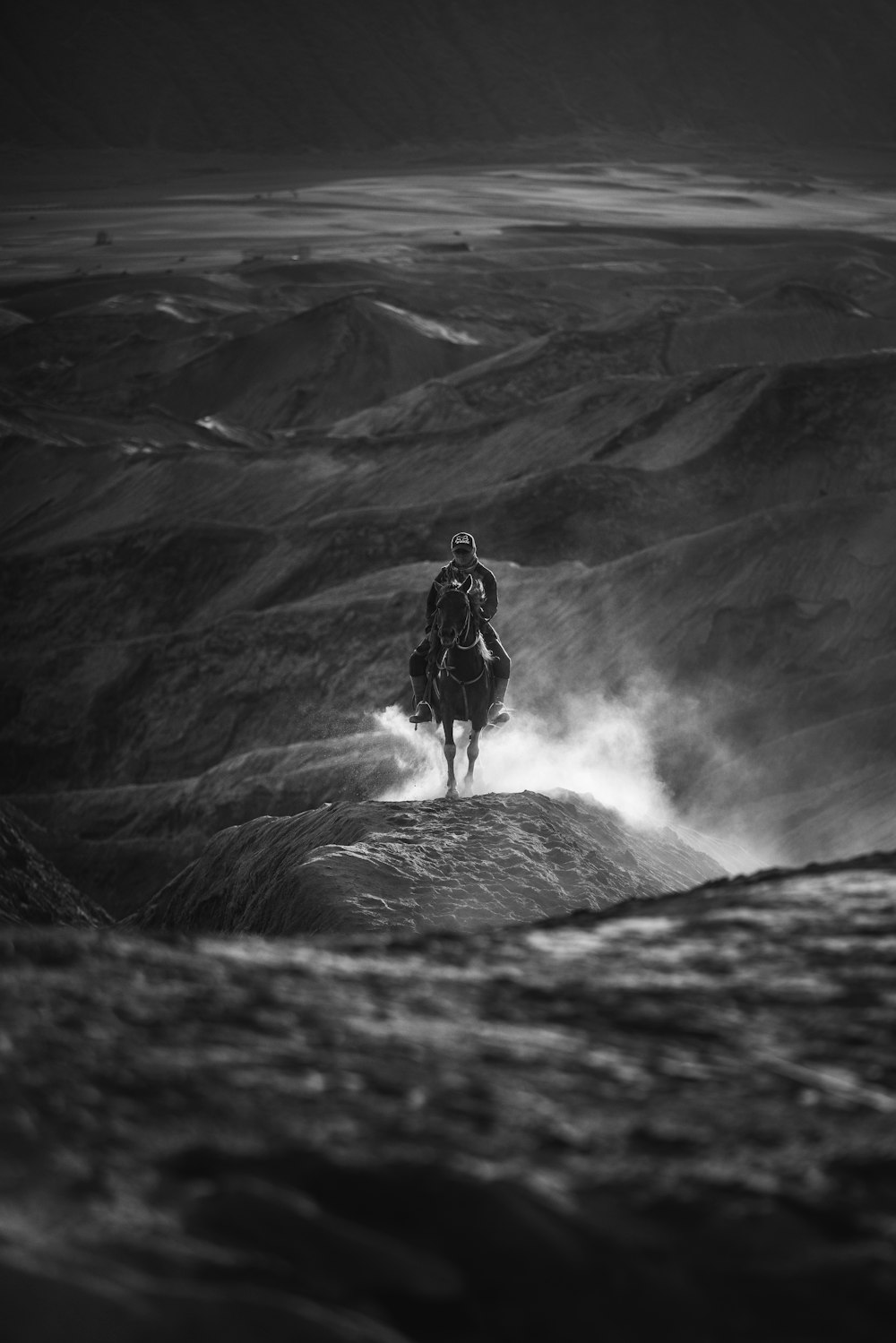 grayscale photography of man riding on horse
