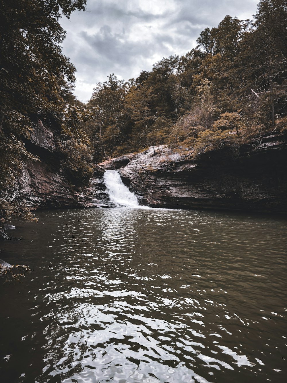 a small waterfall in the middle of a river