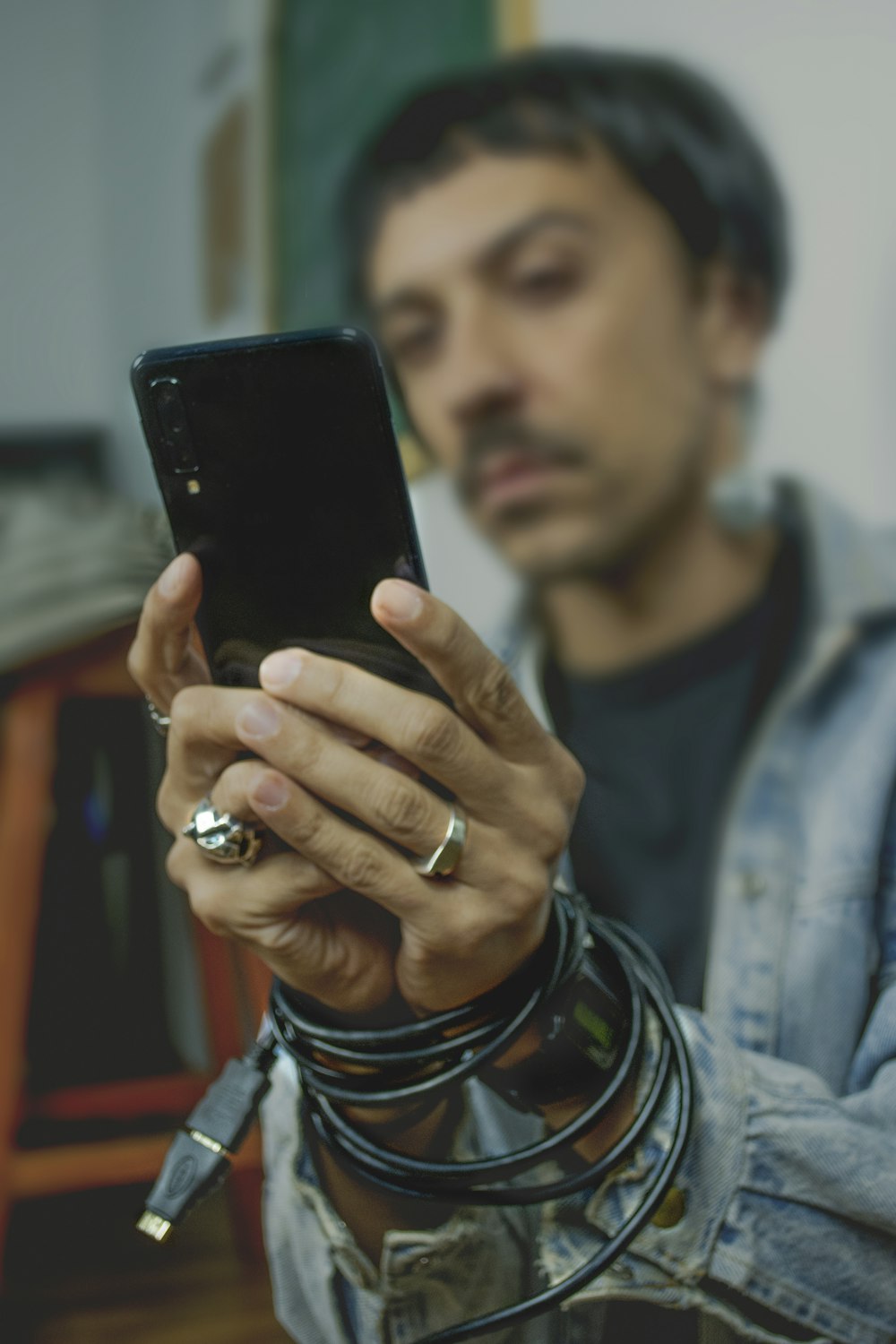 man holding black Android smartphone