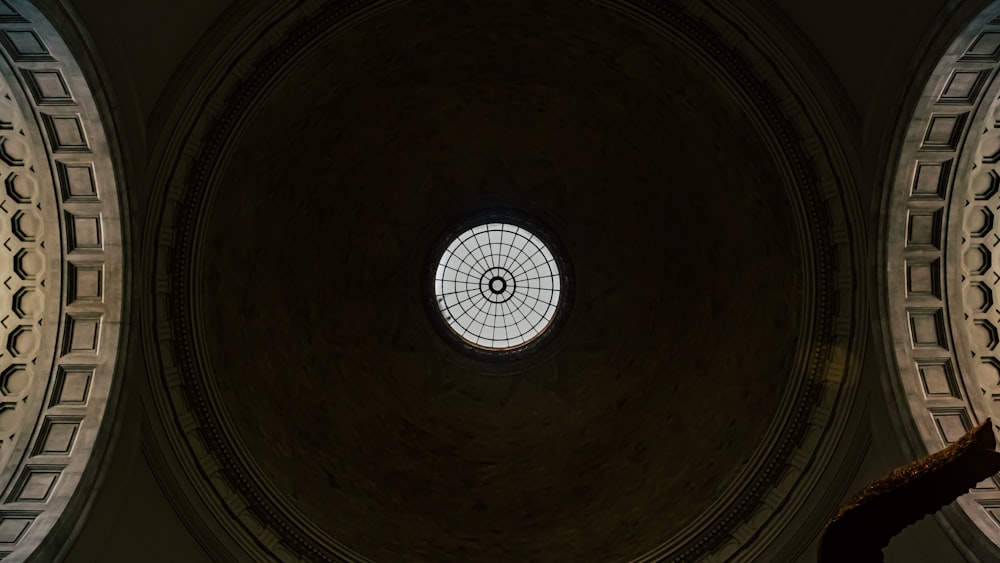 a view of the ceiling of a building with a circular window