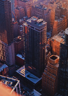 High-rise commercial building in a bustling urban district at sunset.