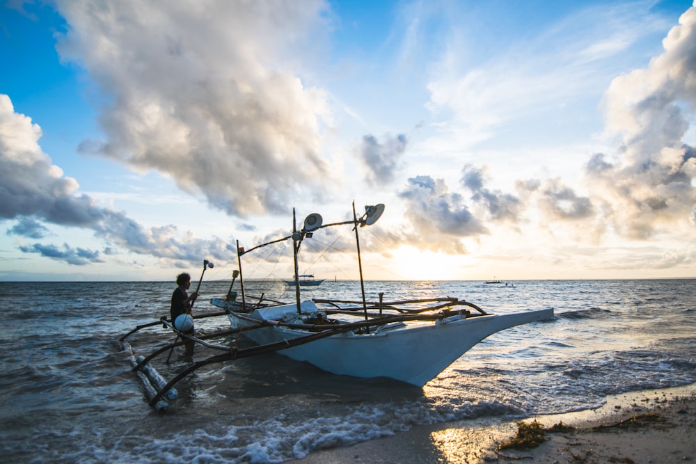 man standing near boat