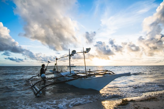man standing near boat in Bantayan Philippines