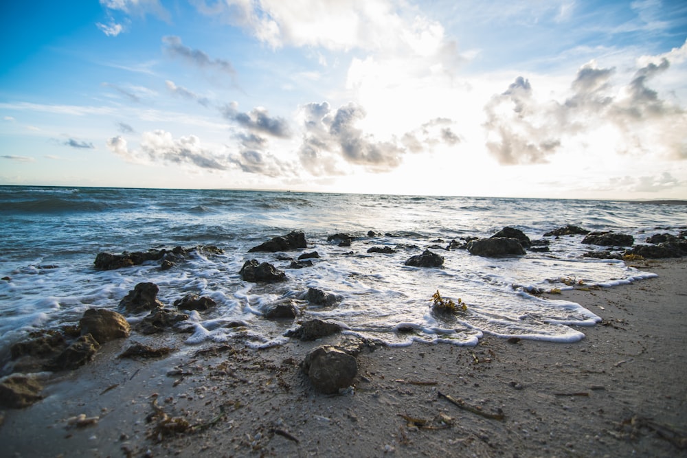 blue beach under blue sky and white clouds