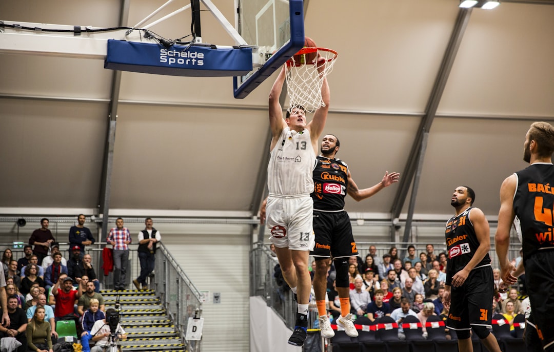 man playing basketball, Dunking. Jonathan Maier 13 (Nürnberg Falcons) vs. Rasheed Lee Moore 23 (wiha Panthers Schwenning