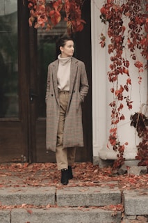 A cozy autumn scene featuring a long coat draped over a chair.