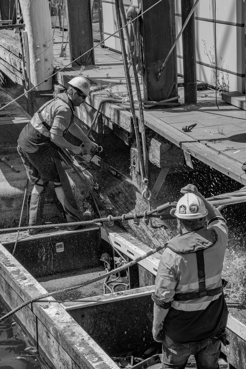 Foto in scala di grigi di una persona in sella a una barca