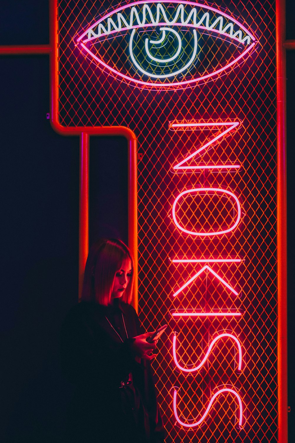 woman beside neon light signage