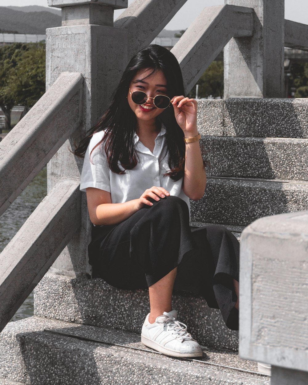 a woman sitting on a set of stairs