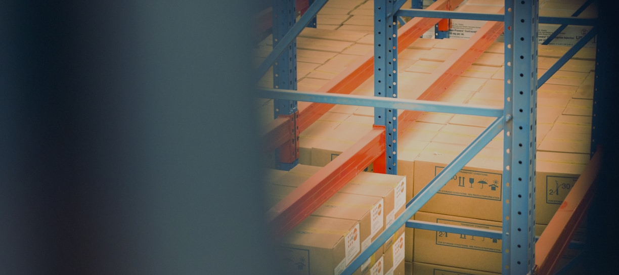 selective focus photography of brown boxes on gray shelf