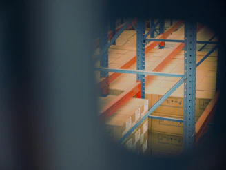 selective focus photography of brown boxes on gray shelf