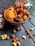 A vibrant assortment of organic dry fruits displayed in a rustic wooden bowl.