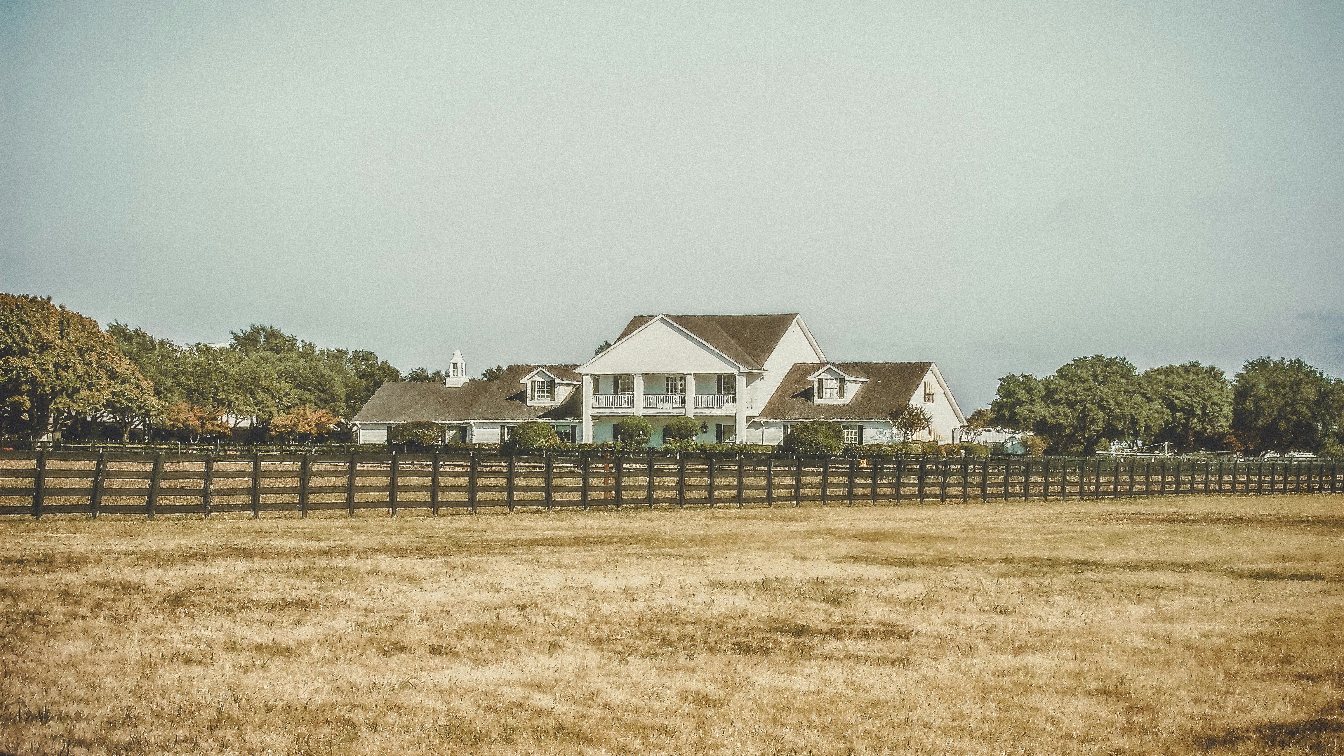 white 2-story house near green trees