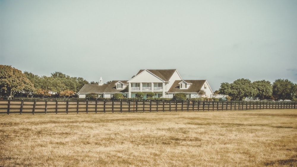 white 2-story house near green trees