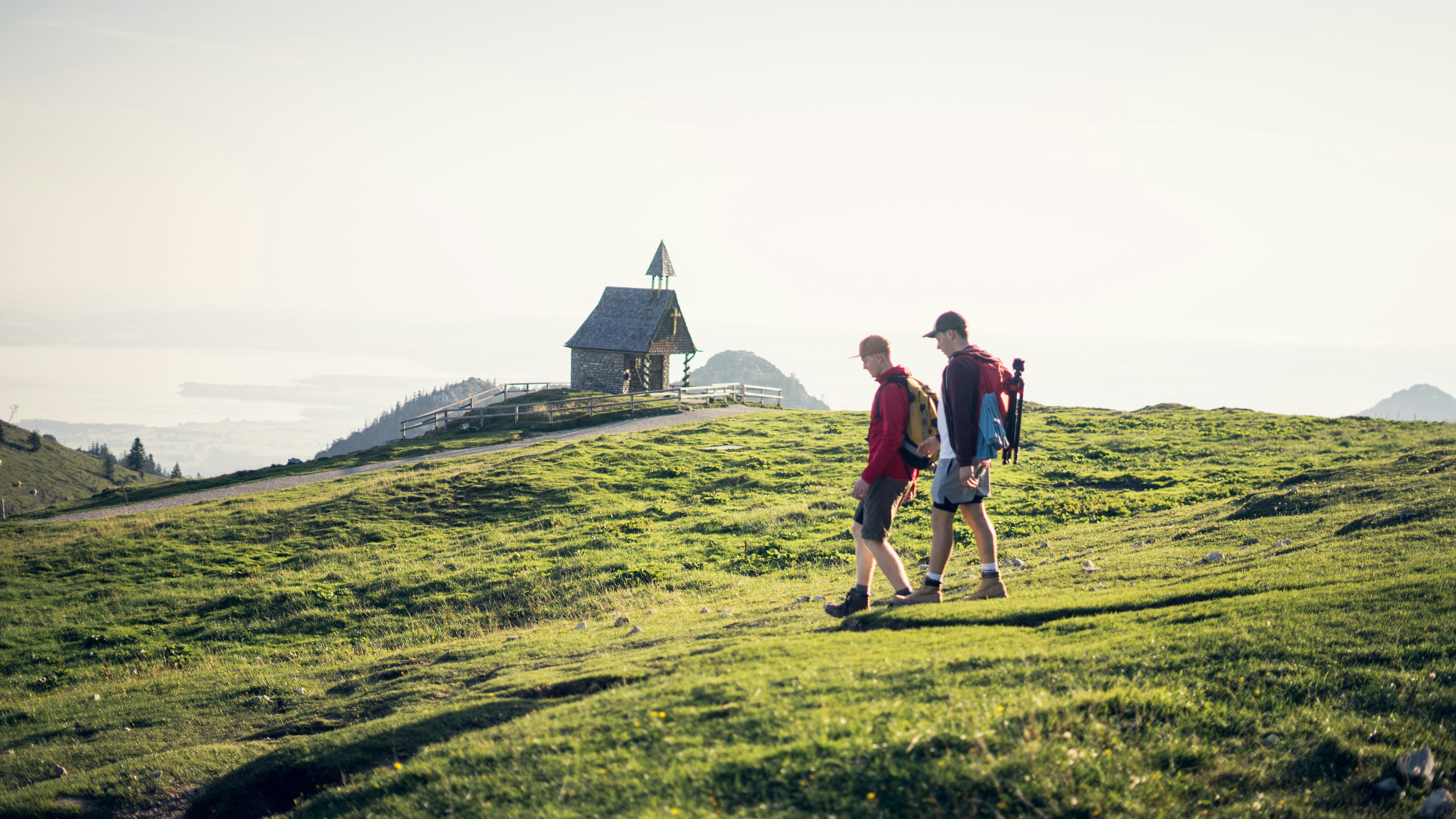two man walking on mountain during daytime