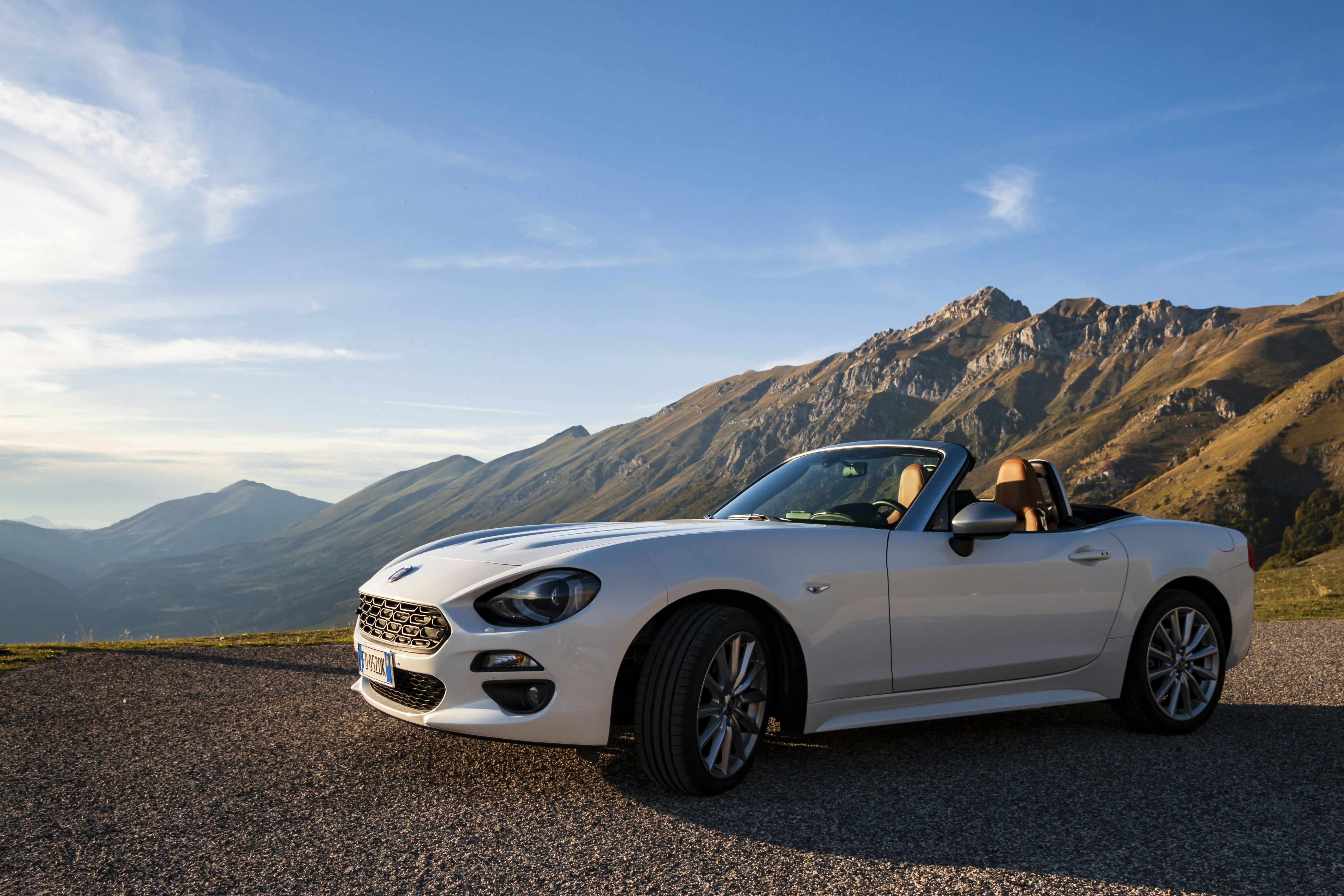parked white convertible coupe during daytime