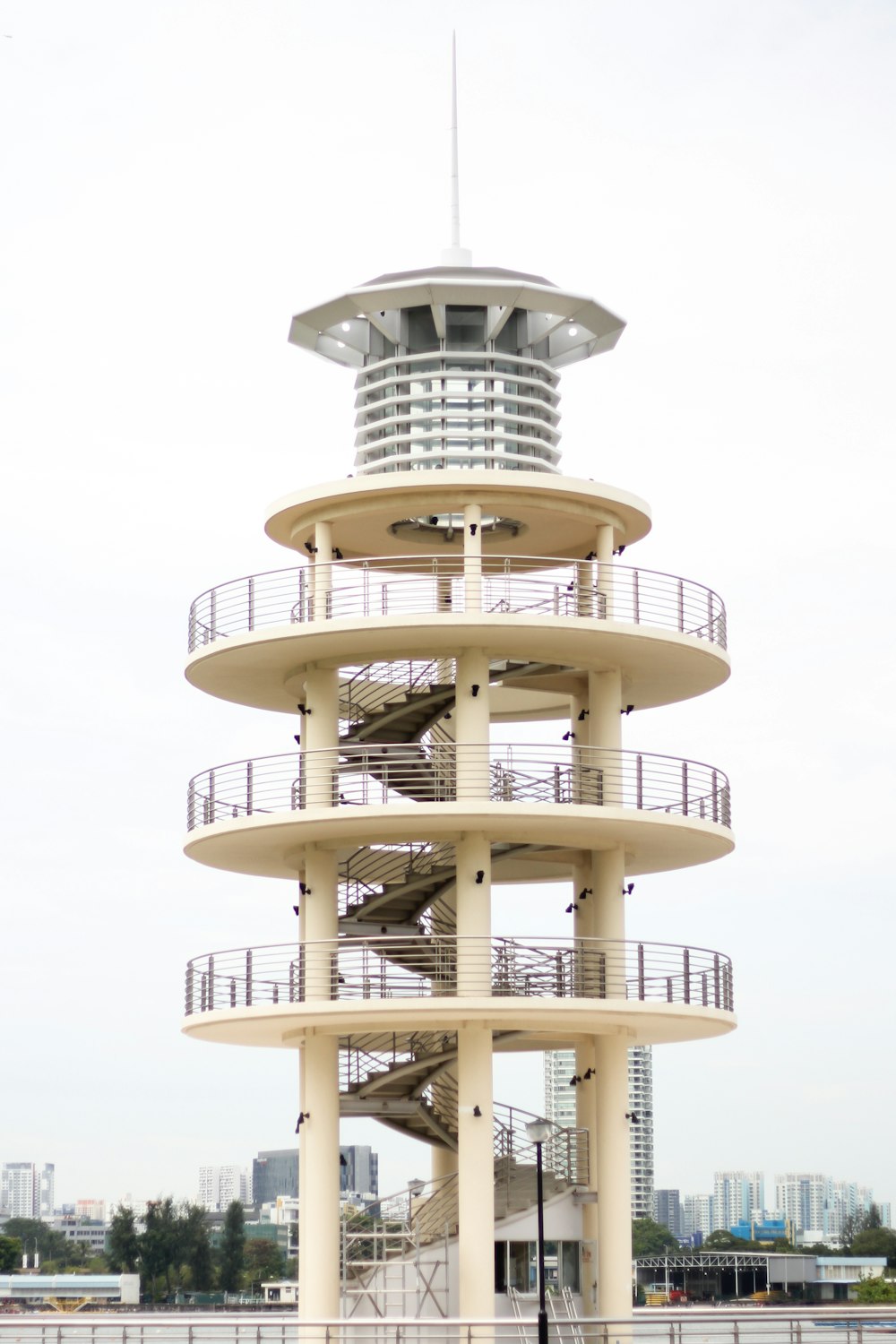 a tall white tower with a clock on top of it