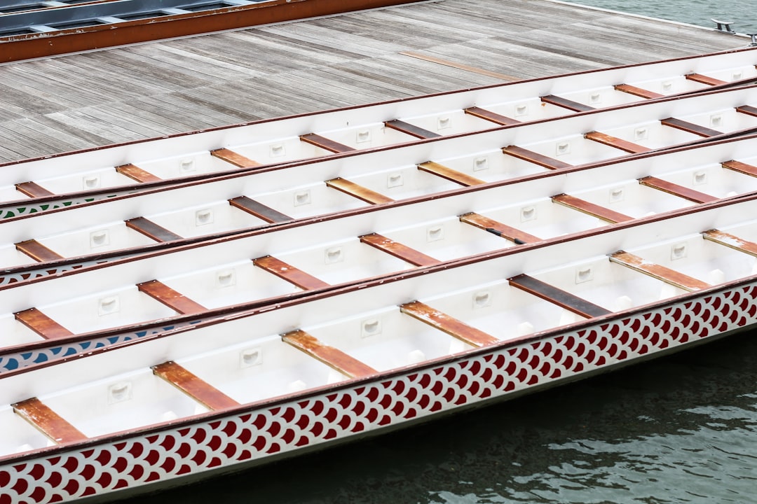 white-and-black wooden boats on dock