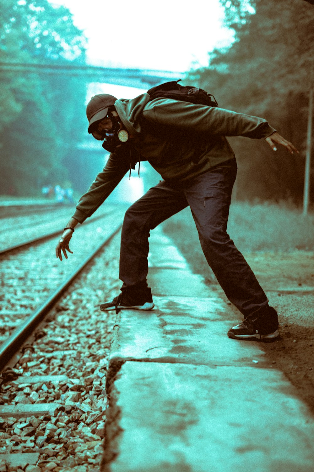 man with respirator on train track