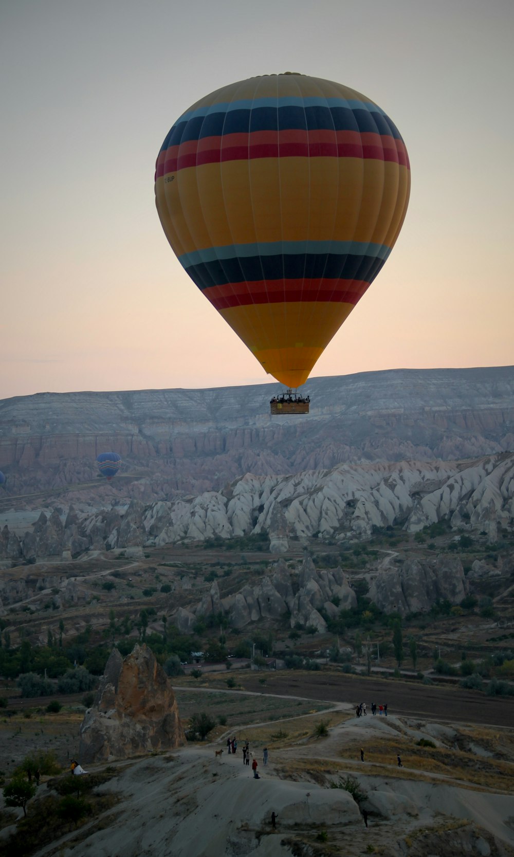 yellow and blue hot air balloon on mid air